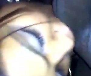 Dark skinned brunette one her knees blowing the dick of a man with a camera