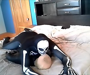 Skeleton against stocking masked wetsuited frogman